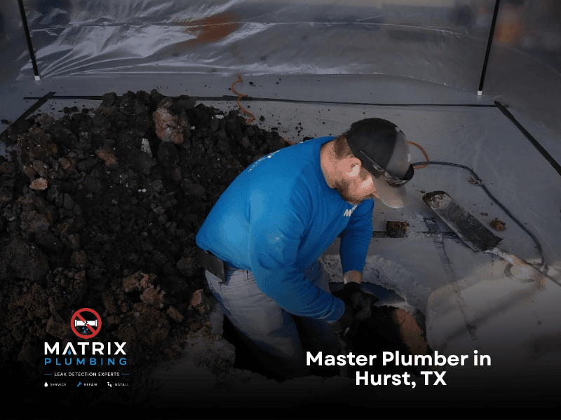 Master plumber from Matrix Plumbing repairing a slab leak beneath a home's concrete foundation in Hurst, TX, providing professional leak detection and plumbing repair services.